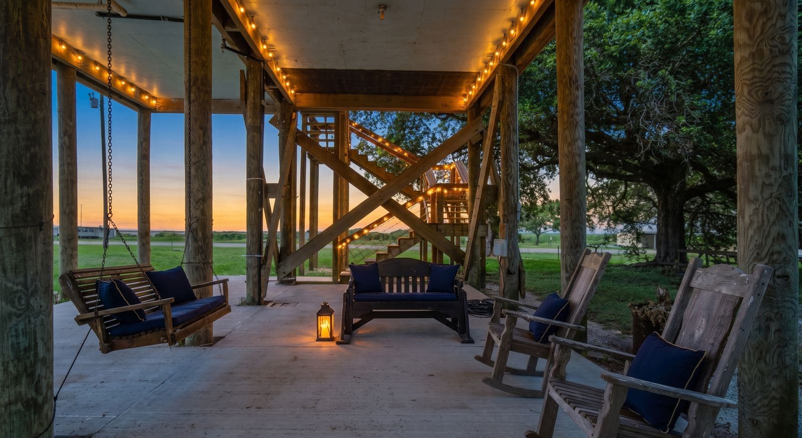 Porch swings in the shaded space beneath the camp